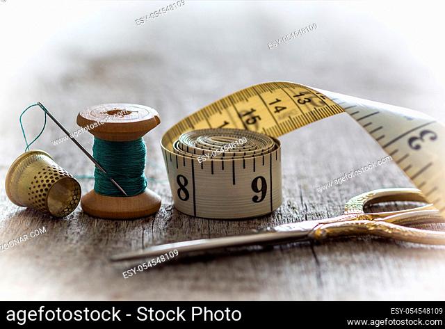 Creative image of tools and accessories for sewing on an old wooden surface. Concept. Selective focus