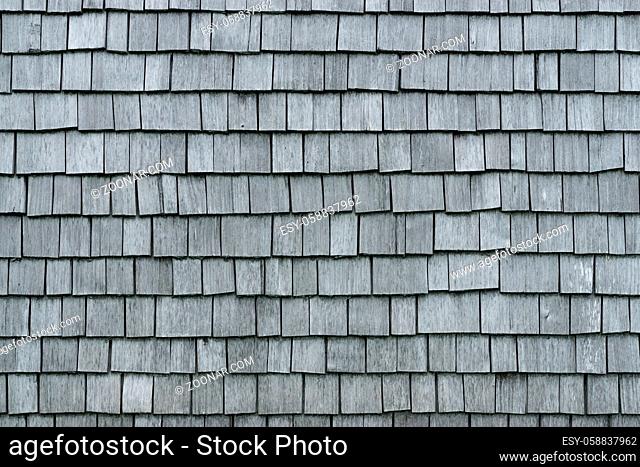 Old weathered Shingles wooden wall background. Traditional shakes with nice grey texture. Bavaria, Allgau, Germany