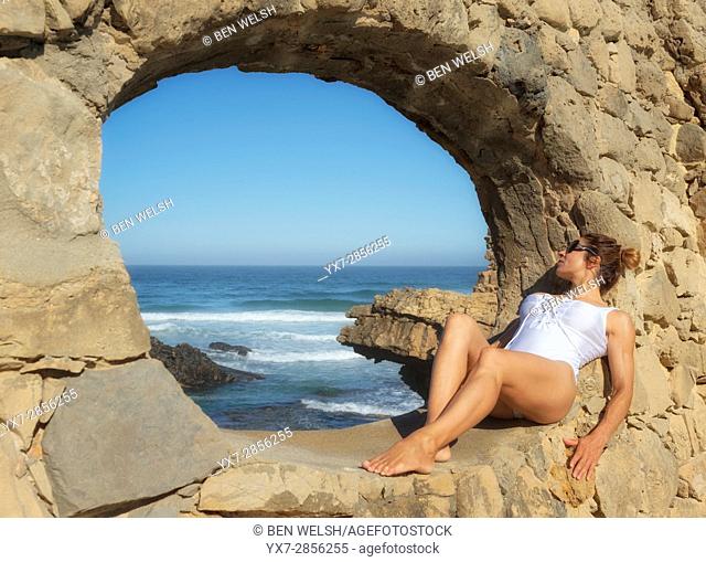 Woman sunbathing at the Muchaxo Hotel, Praia do Guincho, Portugal