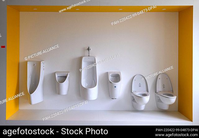 22 April 2022, Mecklenburg-Western Pomerania, Wismar: Various toilet models hang in the former sample room of the former production hall of the insolvent MV...