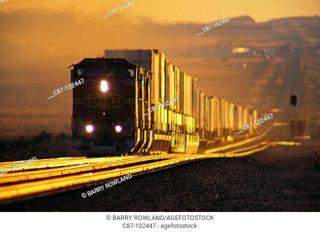 Freight train laboring up hill near Kingman, Arizona, USA
