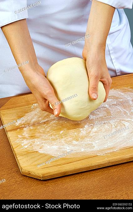 Woman rolls squeezes dough Handmade Series Food recipes Food being prepared and cooked in a contemporary kitchen, with and without the chef