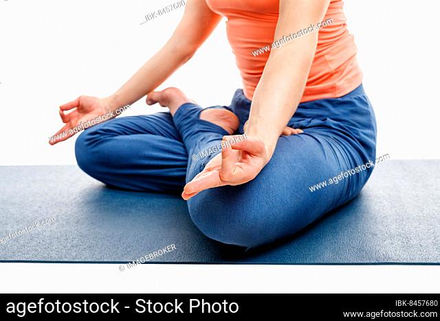 Close up of woman doing yoga asana Padmasana (Lotus pose) cross legged position for meditation with Chin Mudra (psychic gesture of consciousness)