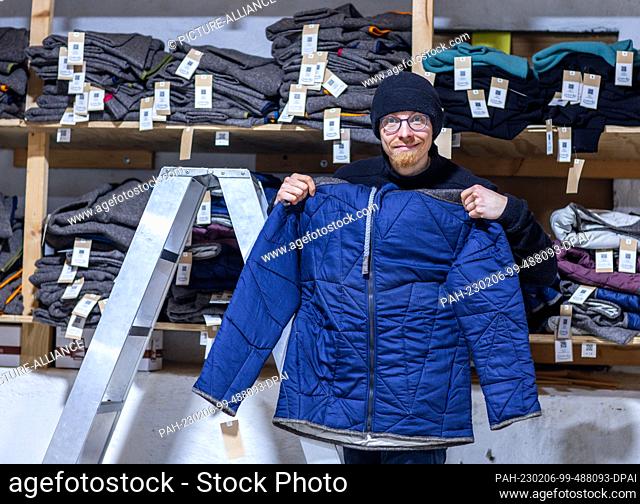 PRODUCTION - 26 January 2023, Mecklenburg-Western Pomerania, Teplitz: Nordwolle founder Marco Scheel shows a jacket from the Nordwolle collection in the factory...