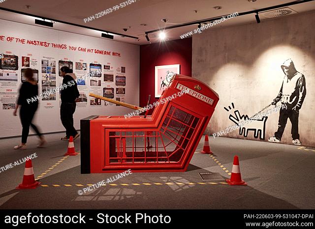 02 June 2022, Hamburg: Employees walk in the exhibition ""The Mystery of Banksy - A Genius Mind"" in the former Galeria Kaufhof