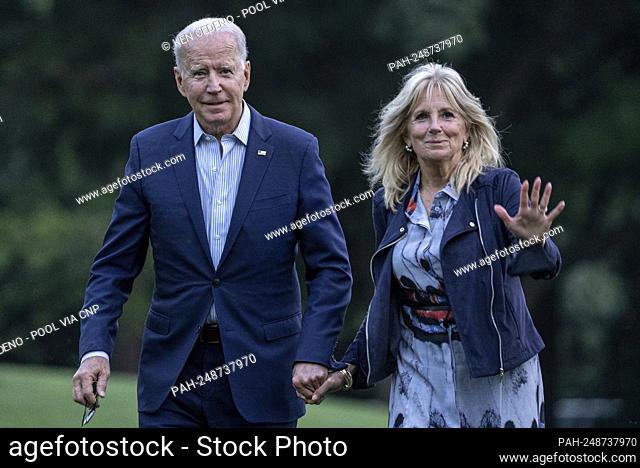 First lady Jill Biden waves to the media as she and United States President Joe Biden walk off of Marine One on the South Lawn of the White House in Washington