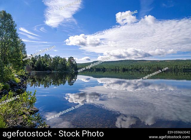 Clouds reflecting in lake Funasdalssjon close to the Swedish village Funasdalen
