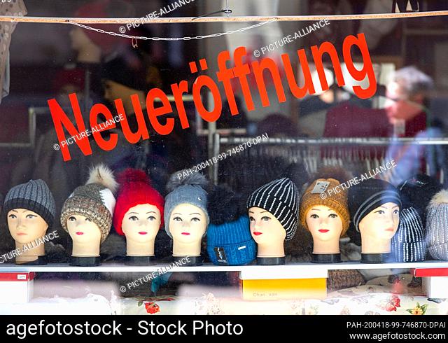 18 April 2020, Mecklenburg-Western Pomerania, Schwerin: The word ""reopening"" is stuck in a shop window of a fashion store