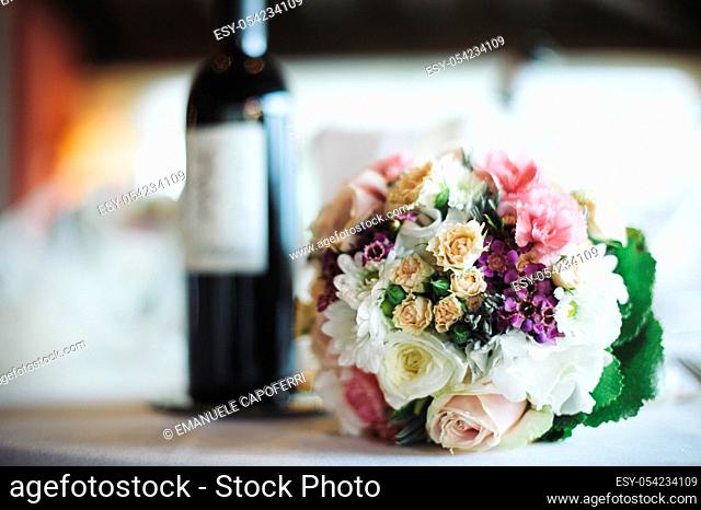 Restaurant table with wine bottle and bouquet