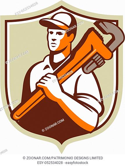 Illustration of a plumber worker wearing hat holding monkey wrench on shoulder looking to the side viewed from front set inside shield crest on isolated...