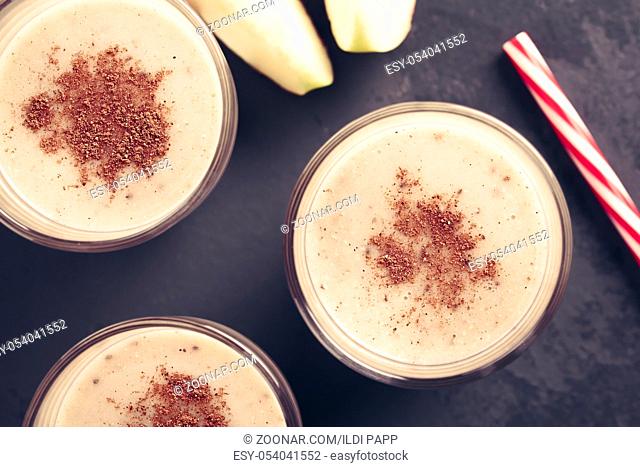Fresh homemade vegan apple, oatmeal and chia seed smoothie with cinnamon in glasses, photographed overhead (Selective Focus
