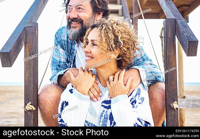 Woman and man smiling outdoor hugging with love. Romantic outdoor leisure activity with young adult couple on vacation. Summer lifestyle people enjoying...