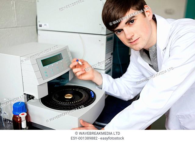 Chemist using a centrifuge in a laboratory