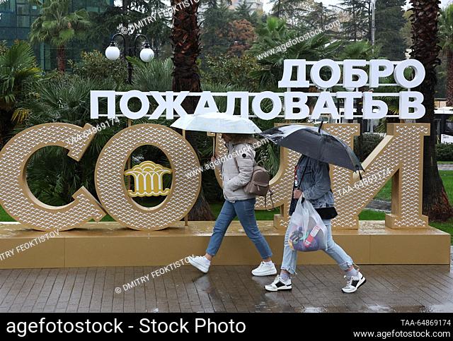 RUSSIA, SOCHI - NOVEMBER 16, 2023: People take shelter under umbrellas during the rain. Dmitry Feoktistov/TASS