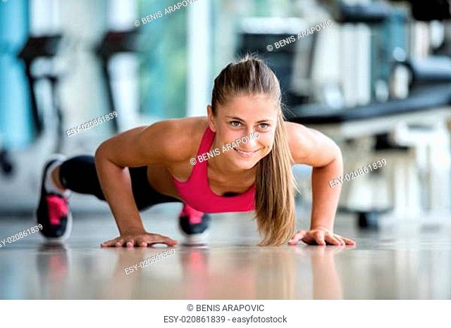 woman exercising on treadmill in gym