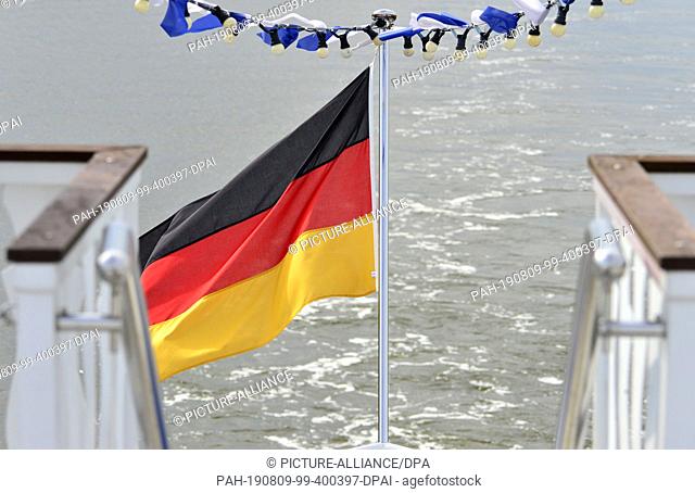 09 May 2019, Mecklenburg-Western Pomerania, Darss: A German flag blows in the wind on an excursion ship on the Baltic Sea