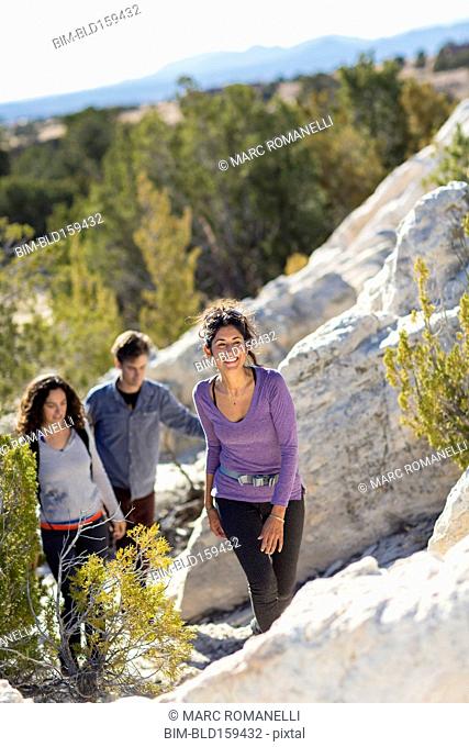 Hikers climbing rocky hillside