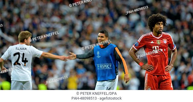 Munich's Dante (R) and Real Madrid's Asier Illarramendi (L) and Casemiro react after the UEFA Champions League semi final first leg soccer match between Real...