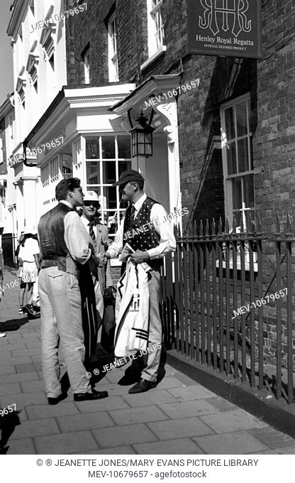 Henley Royal Regatta, Henley-on-Thames, South Oxfordshire. Three men chatting in the street