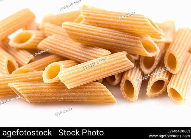 Wholemeal Pasta Penne as close-up shot isolated on white background