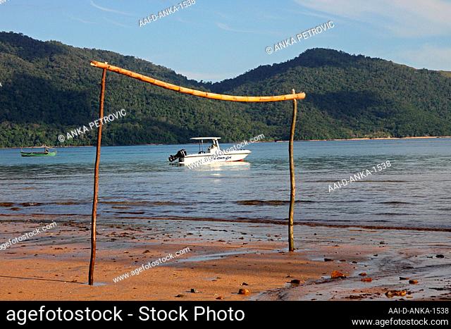Tide poles at the low tide with view of Lokoba Game Rerserve from Ampangorinana Village, Nosy Komba Island, Madagascar