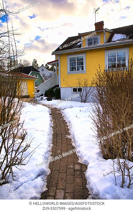 Footpath through snow to yellow timber painted house, Upplands Vasby, Stockholm, Sweden, Scandinavia