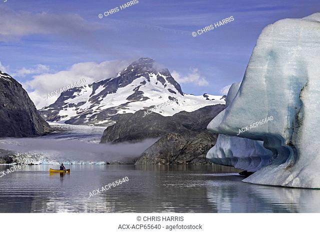 Canoeing near iceberg, Coast Mountains, British Columbia, Canada