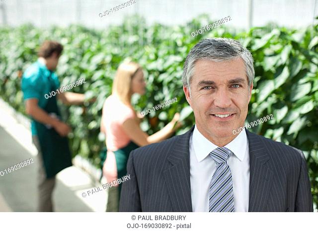 Businessman standing in greenhouse