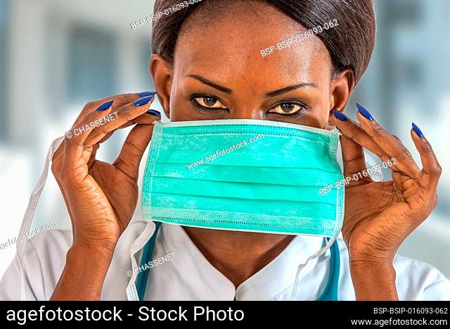 Female american african doctor, nurse woman wearing medical coat with stethoscope and mask. Happy excited for success medical worker