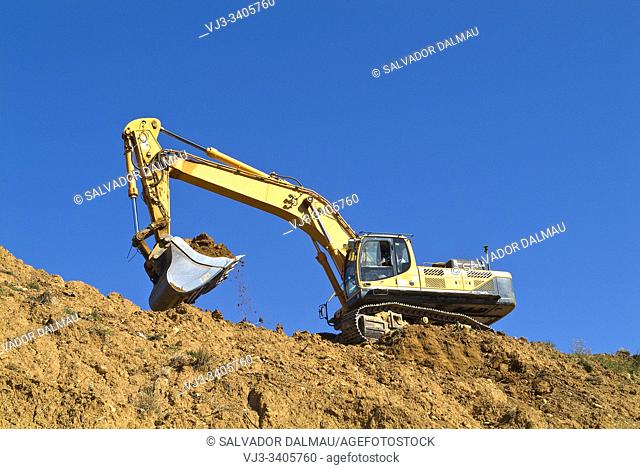 excavator on mountain, location girona, catalonia, spain