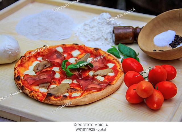 Set of typical Italian products of Bresaola of Valtellina, pizza with mushrooms, tomatoes from Sicily, mozzarella from Naples, Italy, Europe