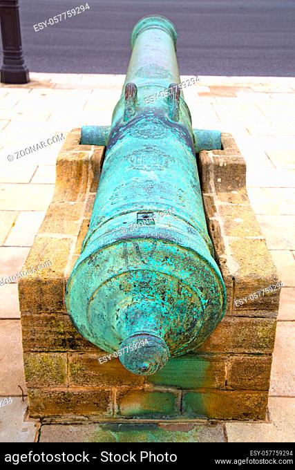 bronze cannon in africa morocco green and the old pavement
