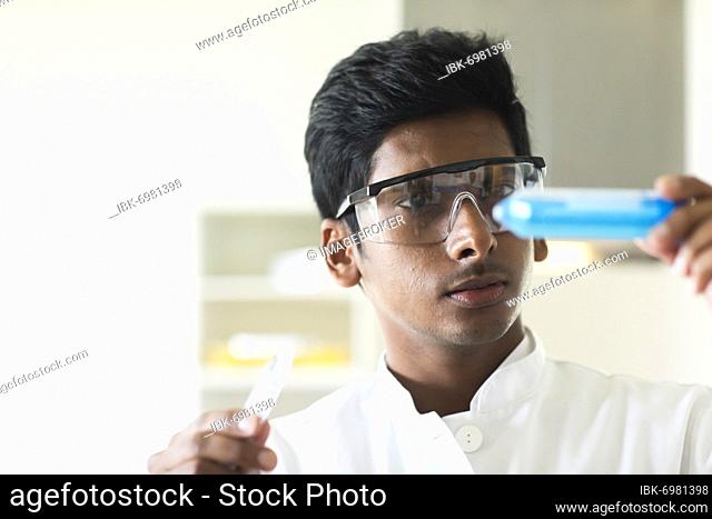 Student in an internship at the university with sample and lab coat, Freiburg, Baden-Württemberg, Germany, Europe