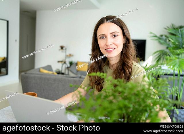 Businesswoman with laptop at home