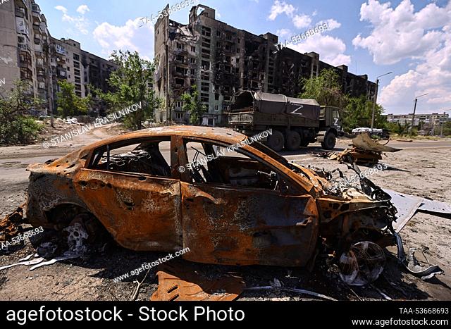 SEVERODONETSK, LUGANSK REGION, UKRAINE – JULY 5, 2022: A burnt out car is seen in a street. The Russian Armed Forces are carrying out a special military...