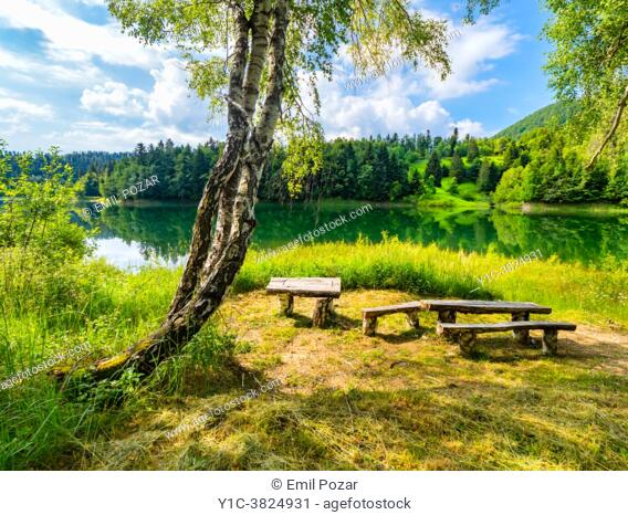 Wooden benches and table Lokve lake near Mrzla vodica in Croatia