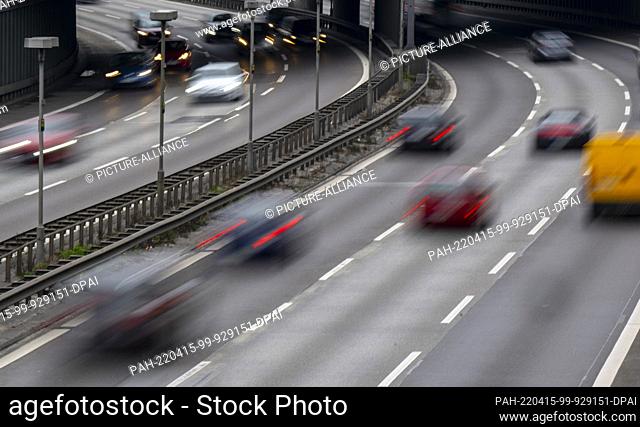 15 April 2022, Berlin: Numerous cars drive over the city highway A100 out of town (r) and into town (wiping effect by long time exposure)
