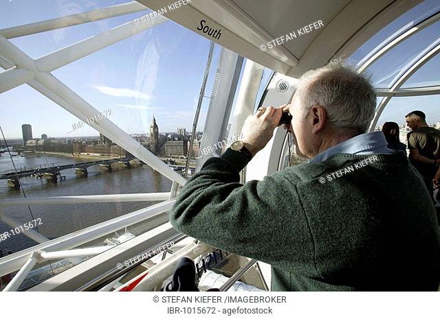 Tourist in a capsule of the Millenium Wheel, looking at Big Ben and the Westminster Bridge, London, England, Great Britain, Europe