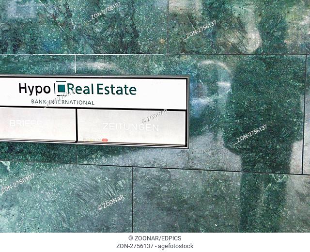 eingangsbereich mit briefkasten der hypo real estate filiale in stuttgart, im blankpolierten marmor spiegelt sich der schatten einer person
