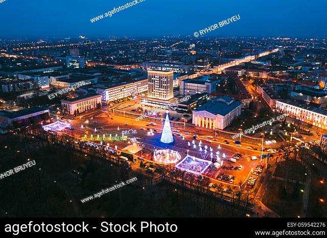 Gomel, Belarus. Main Christmas Tree And Festive Illumination On Lenin Square In Homel. New Year Celebration In Belarus. Aerial Night View