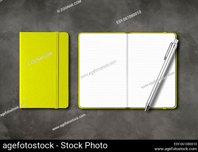 Lime green closed and open lined notebooks with a pen. Mockup isolated on dark concrete background