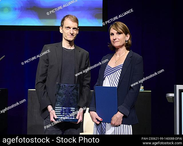 21 June 2023, Berlin: Moritz Aisslinger (Die Zeit, l) receives the Theodor Wolff Award in the Reportage category for ""At the mercy of the storm"" while...