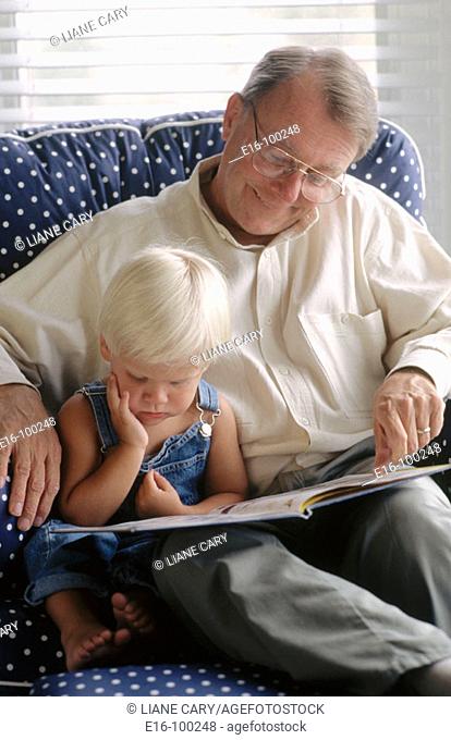 Grandfather reading to grandson