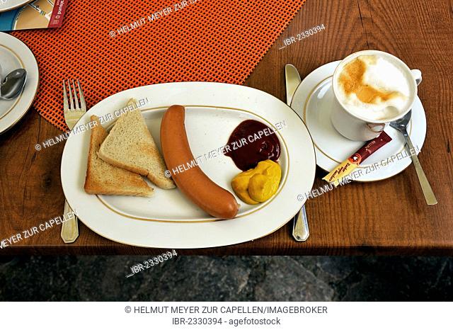 Sausage with mustard and toast, and a cappuccino on the table of a cafe, Stralsund, Mecklenburg-Western Pomerania, Germany, Europe