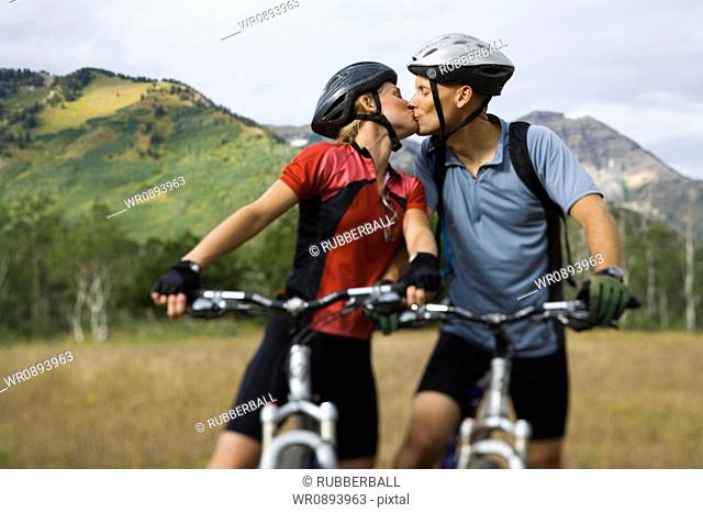 Couple kissing while mountain biking