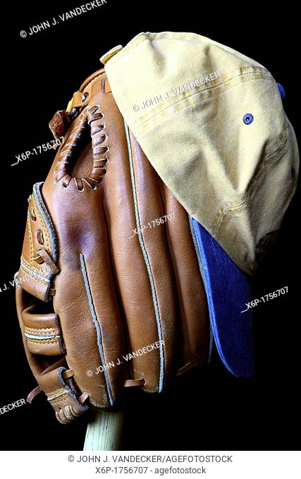 Wait till next year  A baseball glove and cap sitting on a wooden bat