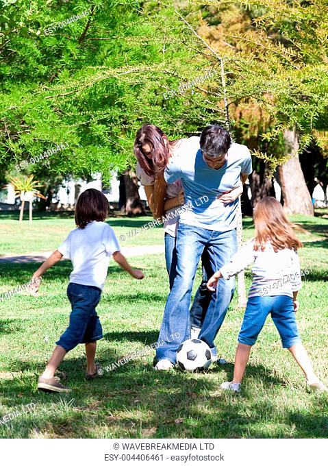 Lively family playing soccer