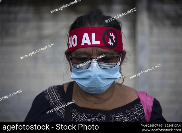 07 September 2021, El Salvador, San Salvador: Marta Alicia López, informal trader, protests against the introduction of the digital currency Bitcoin as a means...