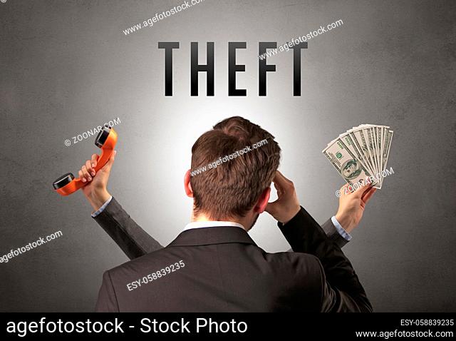 Rear view of a businessman with THEFT inscription, cyber security concept