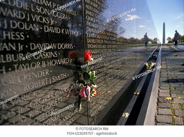 Washington, DC, Vietnam Veterans Memorial Wall, District of Columbia, Red rose placed next to loved one who died in the Vietnam war on the V-shaped black...